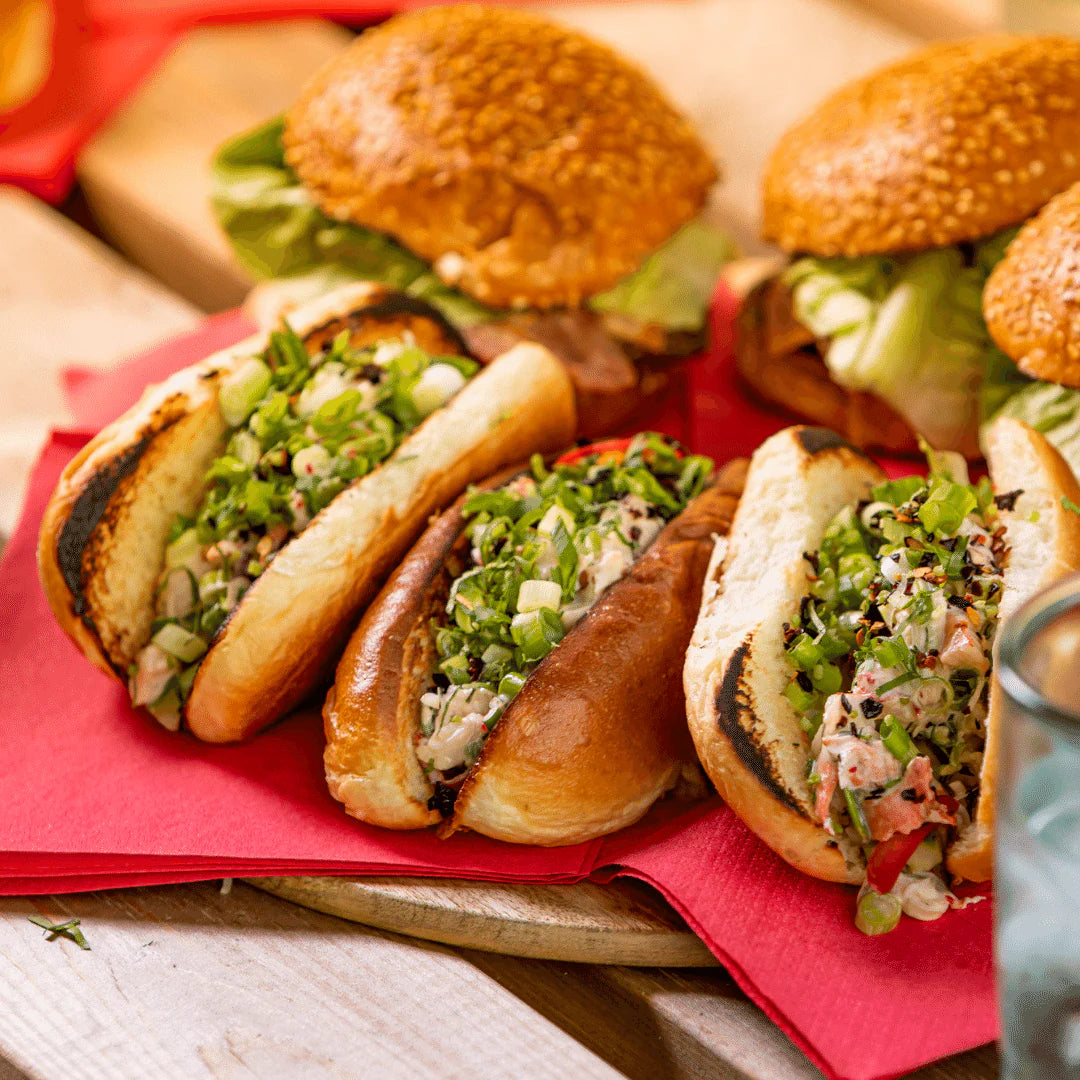 Gourmet Lobster Roll Kit with fresh ingredients in toasted buns on a wooden platter